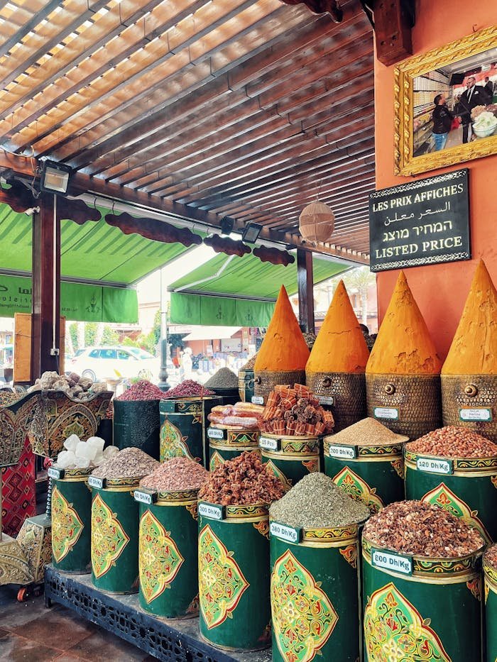 Colorful spices in traditional containers at a Moroccan market stall.